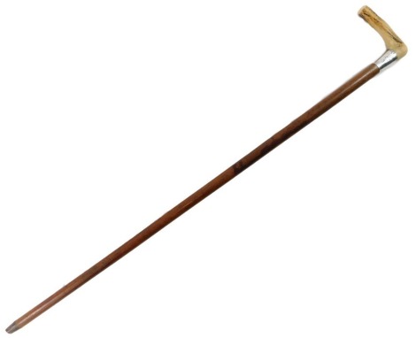 A 20thC malacca walking cane, with antler handle and silver collar, with brass cap, London 1919, 82cm long.