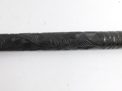 A carved ebony walking stick, with tribal carving and brass cap end, 95cm long. - 2