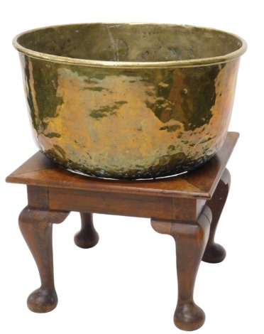 A large brass circular tub/bin, with roll top edge, and with square oak stand and heavy cabriole legs, 71cm diameter.