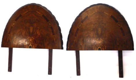 A pair of Victorian inlaid walnut single bed heads, of arched design, with carved lobed borders, having marquetry inlaid decoration, constructed from a loo table top, 88cm wide.