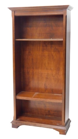 A mahogany open bookcase, of plain design, with moulded cornice and plain frieze, chamfered corners and feet, with three adjustable shelves, 185cm high, 90cm wide, 39cm deep.