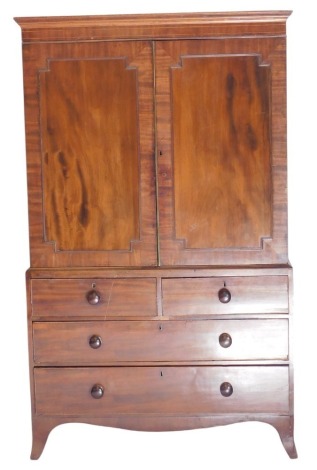 A George III mahogany press cupboard, with plain moulded cornice, two panelled doors, now enclosing hanging compartment, the base fitted with two short and two long drawers, with turned knop handles, on splayed legs, 204cm high, 123cm wide, 57cm deep.