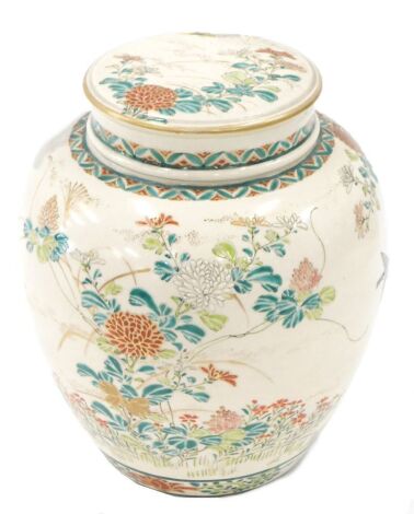 A late 19thC Japanese Satsuma ginger jar, of ovoid design, painted with flowering shrub and butterfly decoration in polychrome enamels, with inner lid and cover, impress mark to the foot, 18cm high.