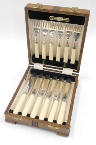 London Cabinet Company oak cased fish eaters, of six knives and forks with ivorine handles, the case with presentation plaque for Flying Officer RB Glover, of the number 12 (B) squadron RAF 1957.