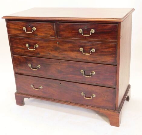 A George III figured mahogany chest of drawers, having two short and three long graduated drawers with brass swan neck handles, raised on bracket feet, 98cm high, 114cm wide.