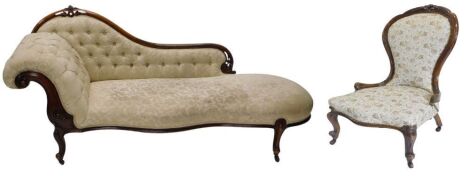 A Victorian walnut framed button upholstered chaise longue, with scrolling carved back and front serpentine front upholstered in cream damask material, raised on French cabriole legs with pot castors, and a low seated balloon back chair to match, in varyi