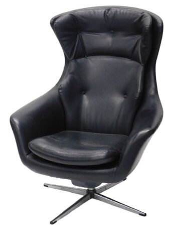 A 1970s black vinyl upholstered swivel chair, with wing back and swept arms, and metal star legged base.