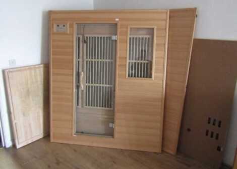 An AbodeFit Health sectional sauna, the door panel measures 185cm high, 156cm wide.