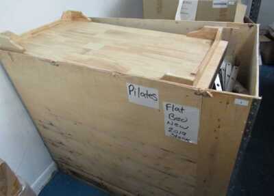 A crate of pilates accessories.