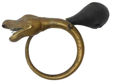 An early 20thC brass serpent's head horn. (AF)