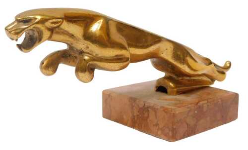 A cast brass Jaguar car mascot, mounted on a pink marble base, 8.5cm high.