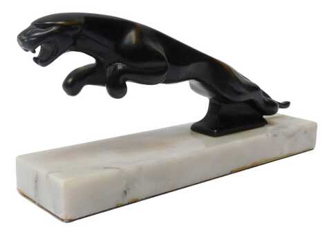 A Jaguar car mascot, possibly bronze, mounted on a marble base, 10cm high.