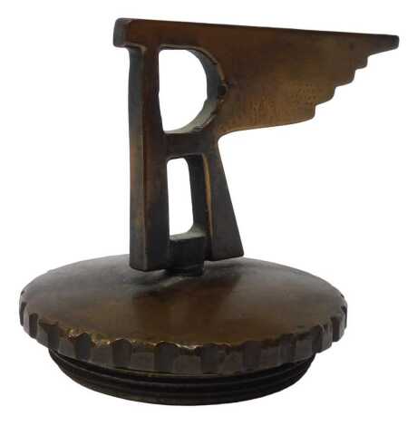 A bronze car mascot, of unknown origin, mounted on a radiator cap, 8.5cm high.