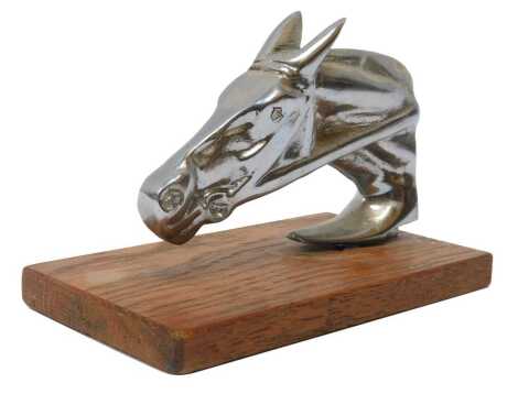 A chrome-plated horse head car mascot, mounted on a wooden base, 9.5cm high.