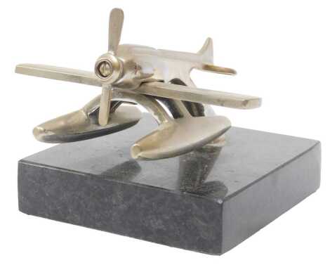 A chrome sea plane mascot, mounted on a black marble base, 7cm high.