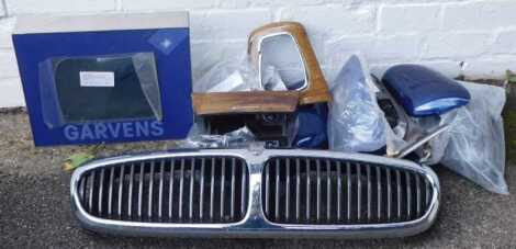 Various car parts and spares, including Jaguar front grill, interior parts, gaiters, wing mirror covers, interior parts, etc.