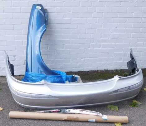 Jaguar car parts, including a front wing, chromed trim, front bumper possibly from an XJS, etc. (1 shelf)