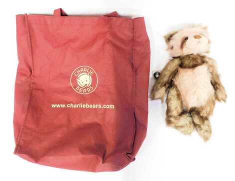 A Charlie Bears Teddy bear, in brown and pink colouring, with bell collar, suede hand and feet pads, 33cm high, in carry bag.