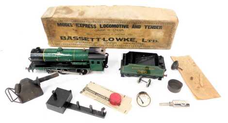 An O gauge tinplate locomotive, in green livery, together with tender, oil dispenser, pressure gauge and accessories, boxed.