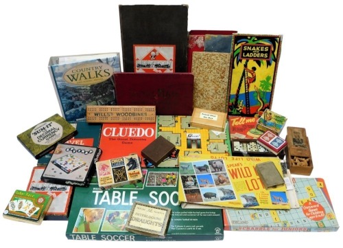 Various board games, including John Waddington Limited Monopoly, Spear's Games Travel Scrabble, Vic Toy Spy Trap, House Martin interlocking draughts, Snakes and Ladders, Waddingtons Cluedo, various playing cards, etc. (1 box)