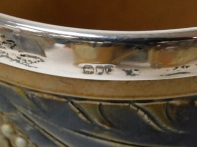 A pair of late 19thC Doulton Lambeth stoneware beakers, with silver mounts, sgraffito decorated with stylised leaves, and moulded with repeating flower heads and beading, impressed marks, London 1889, 14cm high. - 2