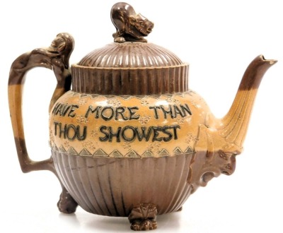 A late 19thC Doulton Lambeth stoneware two tone teapot, of fluted form, the lid with an animal finial, spout with a mask head terminal, and handle topped with a grotesque, the body decorated with "Speak Less Than Thou Naowest, Have More Than Thou Showest" - 2