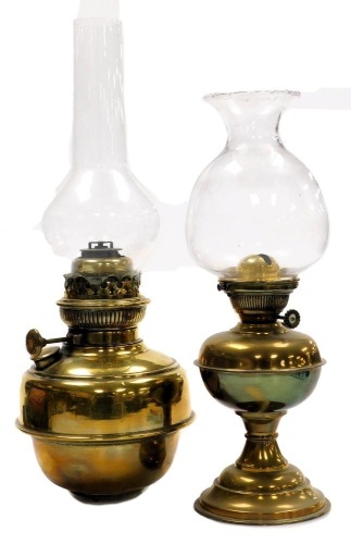 An early 20thC Sherwood Ltd brass oil lamp, with a frilled clear glass shade, 40cm high, together with a further brass oil lamp, possibly from a standard lamp, with glass chimney, 50cm high. (2)