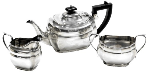 A GeorgeV/Edward VIII/George VI silver three piece tea set, comprising teapot, presentation engraved to the base, cream jug and sugar bowl, Birmingham 1938, Chester 1935, Chester 1936, 35.31oz.