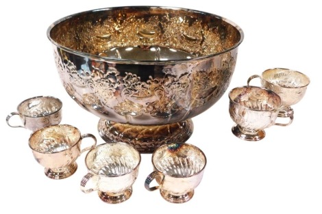 A Viners silver plated punch bowl, with engraved floral and c scroll decoration, 38cm wide, together with six cups.