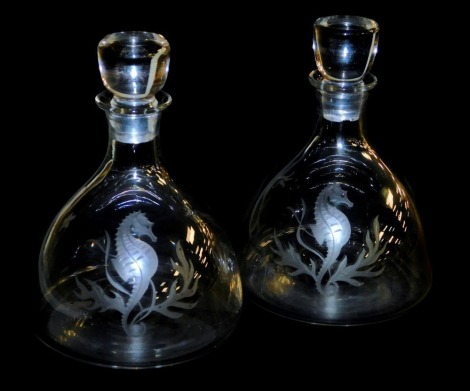 A pair of 20thC cut glass decanters and stoppers, engraved by Alison Geissler, signed, with seahorses and seaweed, 19cm high.