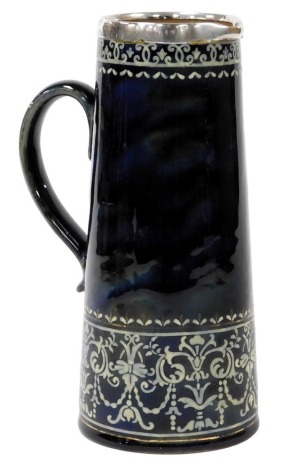 A late 19thC Doulton Lambeth stoneware jug, with silver rim, decorated in white with foliate swags, against a colbalt blue ground, impressed marks, London 1895, 23cm high.