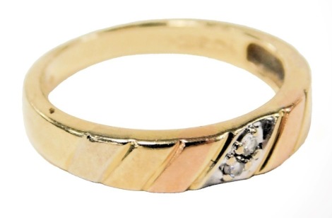 A two stone diamond set wedding band, in three colour metal, stamped 14k, size M/N, 2.7g.