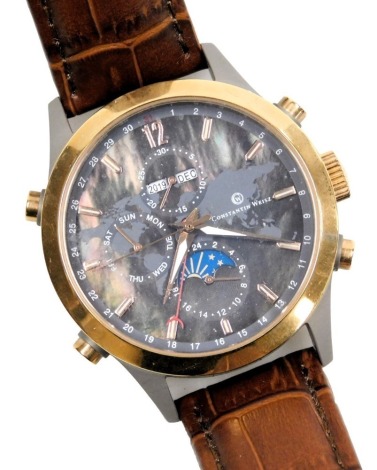 A Constantin Weisz brushed and gilt metal cased gentleman's chronograph wristwatch, circular black dial with map of the world, centre seconds, three subsidiary dials, on a brown leather strap.