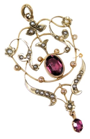 An Edwardian amethyst and seed pearl brooch, in a scrolling floral and foliate design, set in yellow metal, stamped 9ct, 2.8g. (AF)