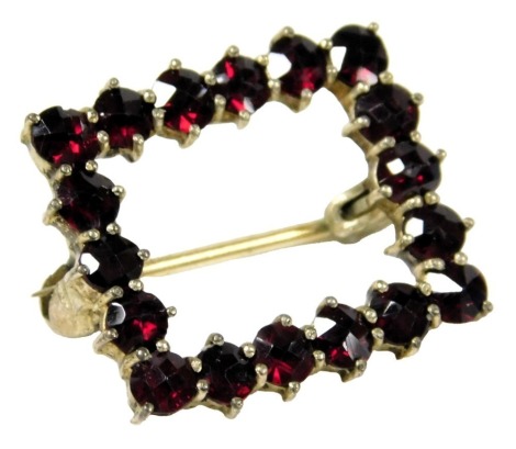 A Victorian garnet paste set brooch, in a rectangular metal frame.