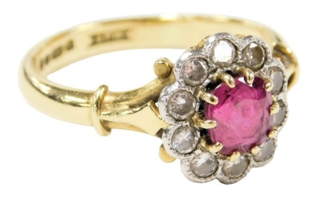 An 18ct gold, ruby and diamond flower head ring, the ruby approx ½ct, diamonds approx &#8531?ct, size O/P, 4.2g.