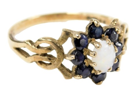 A 9ct gold opal and sapphire ring, in a floral design, with pierced shoulders, size P, 2.0g.