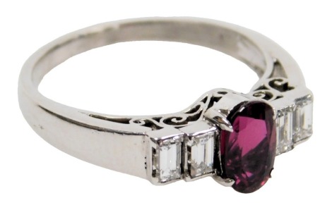 A 14ct white gold, corundum and diamond ring, set with an oval cut central corundum flanked by four emerald cut diamonds, corundum 0.95ct, diamonds 0.36ct, with a WGI jewellery report, size L, 3.2g.