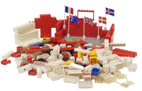 A group of early Lego bricks, bases, flags etc.