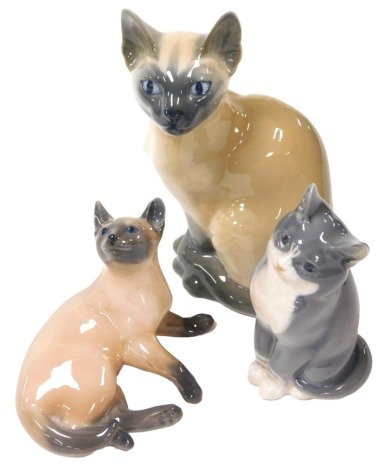 A Royal Copenhagen porcelain figure of a seated Siamese cat, No. 3281, a further Siamese cat, No. 2862, and a kitten, No. 1803, printed and painted marks. (3)