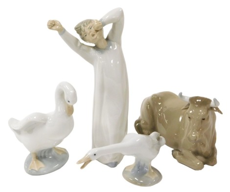 A Lladro porcelain figure of a boy, modelled standing, yawing and stretching, 22cm, together with a Lladro figure of a goose, a Nao figure of a goose and a figure of a recumbent cow. (4)