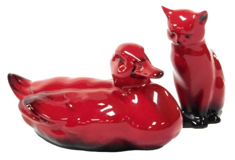 A Royal Doulton Flambe figure of a duck, printed mark, 19cm wide, and a further figure of a seated cat. (2)