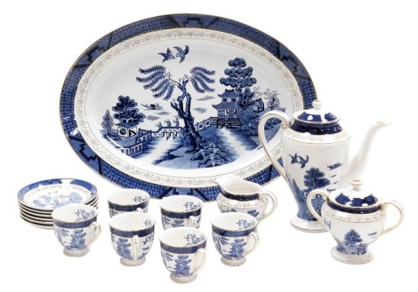 A Japanese double phoenix pottery Willow pattern part coffee service, comprising coffee pot, cream jug, sucrier, six coffee cups and saucers, together with a Willow pattern meat plate.