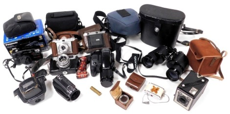 An Olympus IS-1000 digital camera, further cameras, including Balda, Edixa, and Yashica, and a pair of Swift Technar 12x50 binoculars. (a quantity)