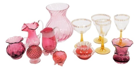 A group of Victorian cranberry glass, including jugs and vases, together with 1950s amber stemmed wine glasses. (a quantity)