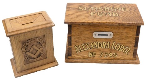 Two early 20thC Masonic oak contribution boxes, Sunshine Fund, Alexandra Lodge Number 7245, 26cm wide, and Litherland Lodge Number 3676, with plaque to base, presented by Bro FM Shaw, IG, To the Litherland Lodge Number 3676 1913, 18cm high. (2)