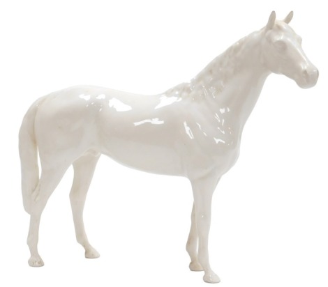 A Beswick pottery figure of a dappled grey racehorse, printed mark, 37cm wide.