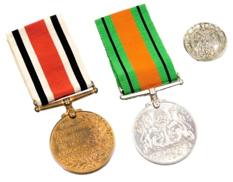 A World War II Defence medal, named to George W Saxby, together with a Faithful Service in the Special Constabulary medal, also named, Loyal Service Lapel badge, and a handwritten partial family tree.