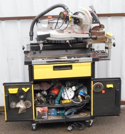 An SIP sliding compound mitre saw, with laser, number 01314, on a table cabinet base, containing further assorted tools.