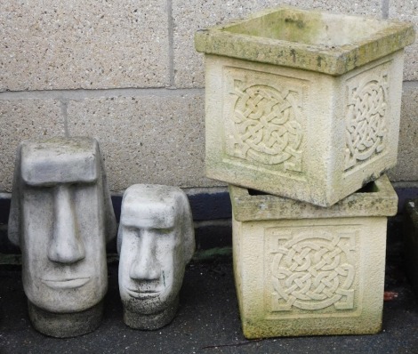 A pair of reconstituted stone Easter Island type heads, 38cm x 27cm high respectively, together with a pair of concrete planters, of square form, with Celtic knot decoration, 31cm high, 32cm wide.